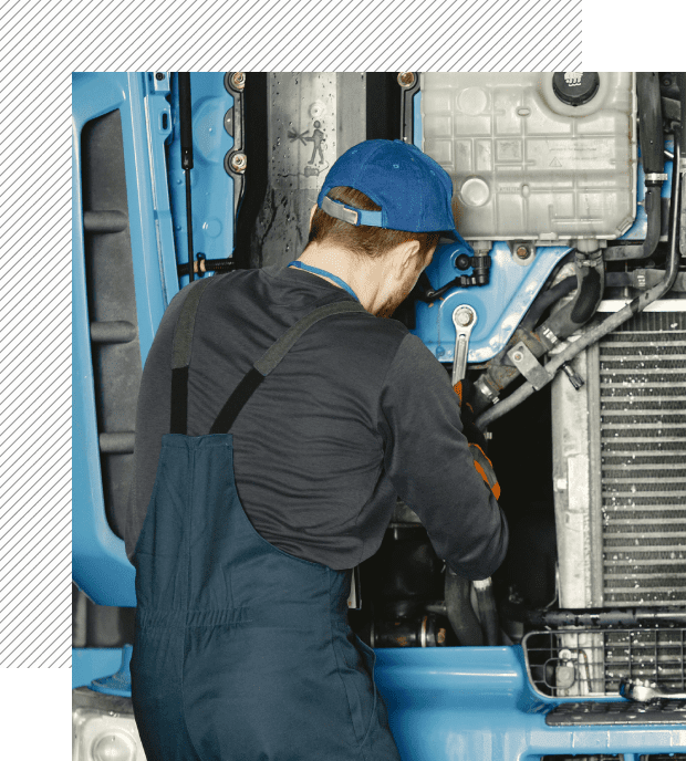 A man working on an engine of a truck.